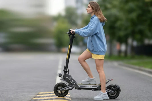 Young woman riding Freeboy J2 Max electric scooter crossing road speed bump on city street
