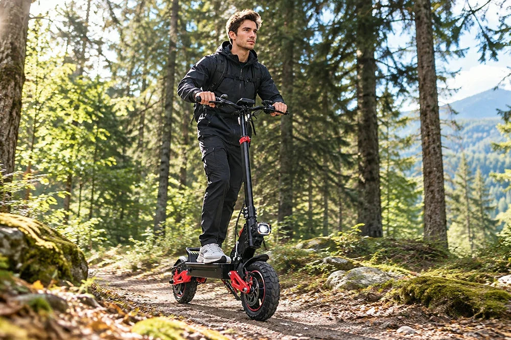 Man riding Freeboy J15 Max electric scooter on rocky forest trail.